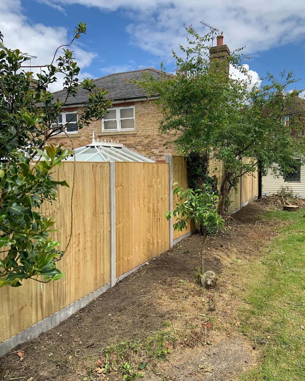 This is a photo of fence panels installed in a residential garden using concrete posts and gravel boards. Installed by Fast Fix Fencing Thetford
